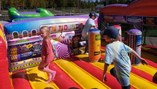 Children playing in a bouncy castle during NU Homecoming 2025