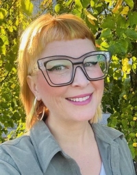 A woman taking a selfie in front of a nature background