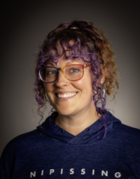 A woman headshot picture with nature background