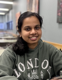 A student in dull green hoodie