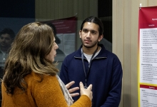 Students and community members networking and showcases research posters