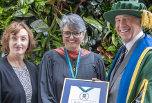Catherine Gregory and Chancellor Russell stand with Maria Cristina Aguilera Valle, recipient of this year's Chancellor's Medal for Humanity