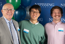NU students pose with donor Jack Jones and Chancellor Russe;l