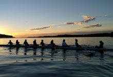 varsity rowing team on the water