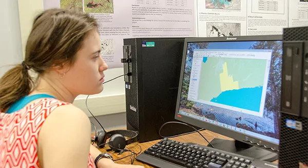 student on a computer in the geomatics lab