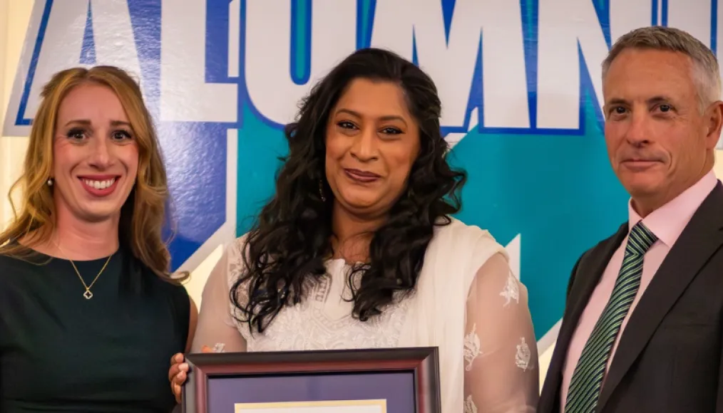 Sabah Khan is presented with the Dr. James Jamieson Alumni Award by Laurel Muldoon and Dr. Kevin Wamsley