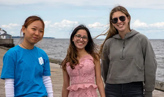3 students on the dock at the waterfront
