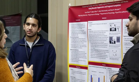 Students and community members networking and showcases research posters