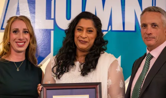 Sabbah Khan is presented with the Dr. James Jamieson Alumni Award by Laurel Muldoon and Dr. Kevin Wamsley