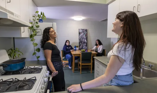 A group of NU students socializing in residence kitchen