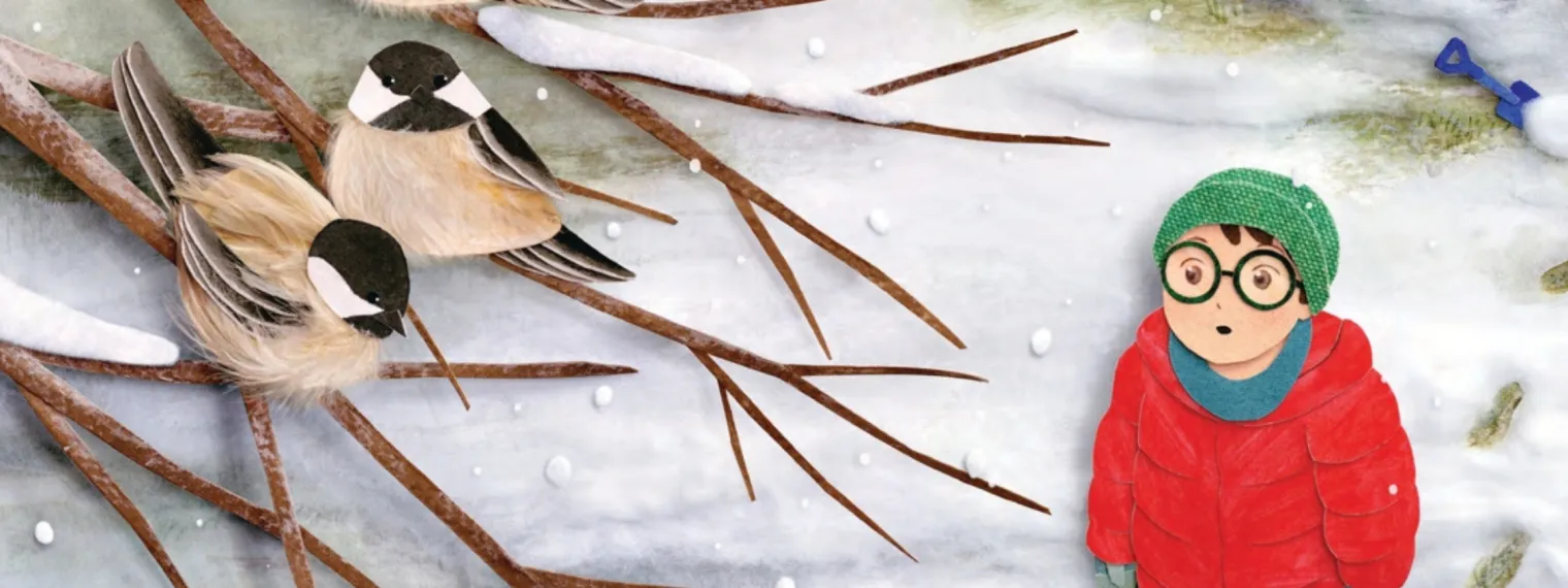 A child stands in the snowy forest looking up at two birds in a tree branch.