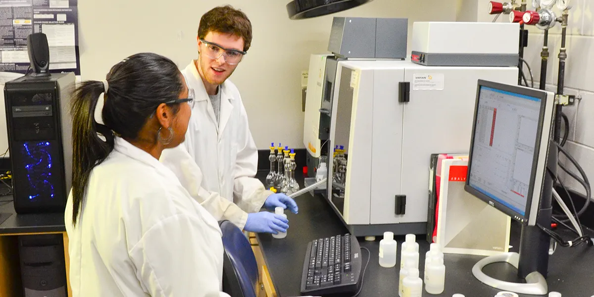 two students in lab coats