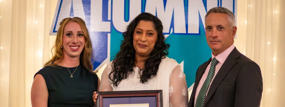 Sabah Khan is presented with the Dr. James Jamieson Alumni Award by Laurel Muldoon and Dr. Kevin Wamsley