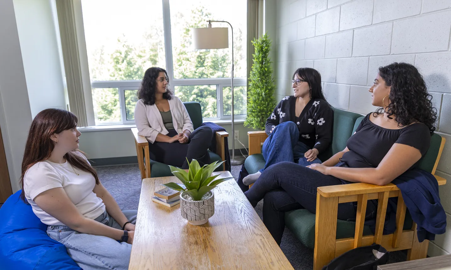 A group of NU students socializing in residence living room