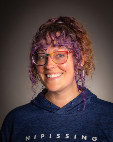 Woman in Nipissing sweater smiling