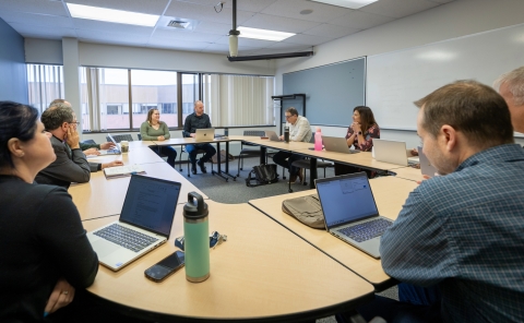 Alessia Montroy sits with senates of the Teaching and Learning Committee