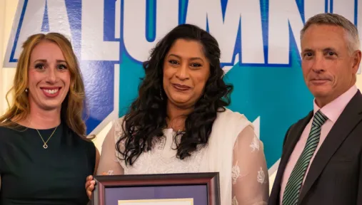 Sabbah Khan is presented with the Dr. James Jamieson Alumni Award by Laurel Muldoon and Dr. Kevin Wamsley