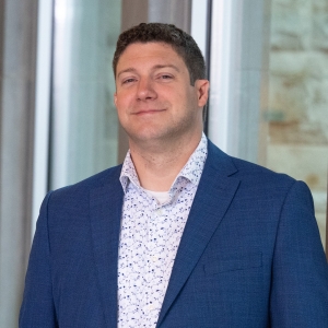 Headshot of Steve smiling into the camera