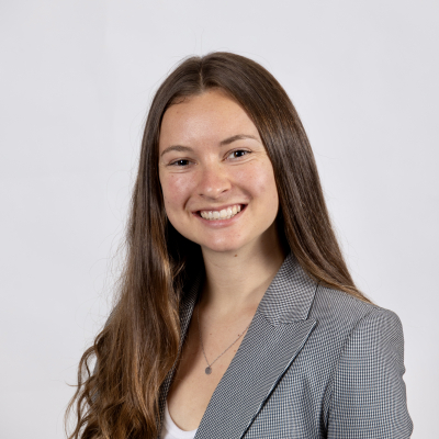 Photo of Sarah McAllister in a gray blazer with long, dark blonde hair