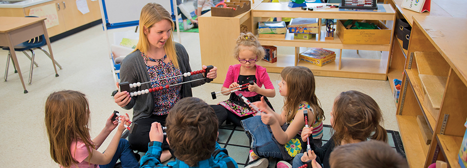 Education student teaching a small group of student